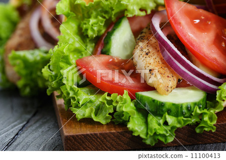 pair of fresh juicy wrap sandwiches with chicken and vegetables 11100413