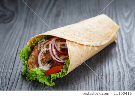 tasty fresh wrap sandwich with chicken and vegetables 11100416