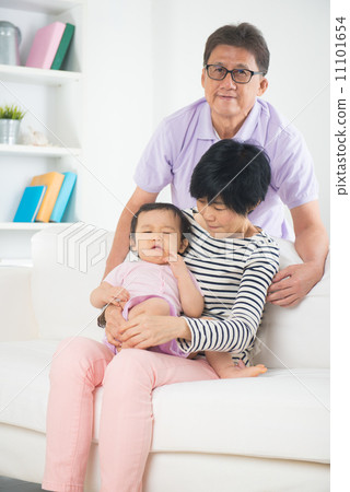 asian grand parents comforting their spoilt crying grand daugthe