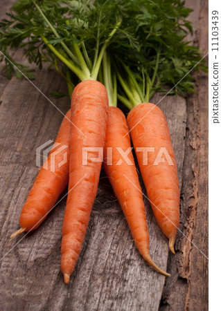 fresh carrot bunch on grungy wooden background 11103439