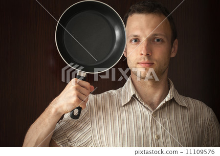 Young man portrait with black frying pan Young man portrait with black frying pan 11109576