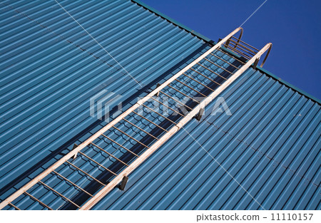 metal ladder on blue metal wall 11110157