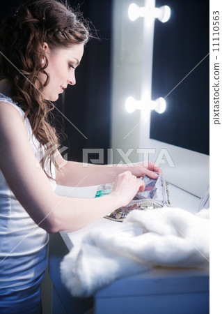 beautiful girl in a make-up room in front of the mirror 11110563