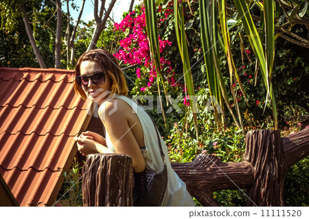 Woman on holidays. Flowers in the back Woman on holidays. Flowers in the back 11111520