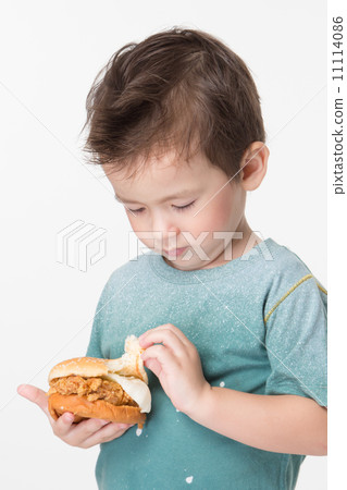 Boy eating a burger 11114086