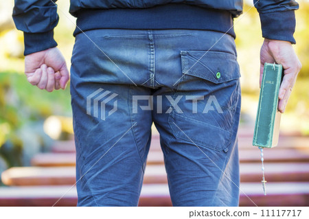 Religious man with Holy Bible and Rosary 11117717