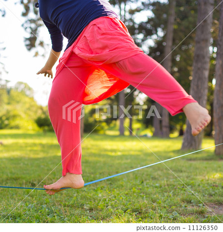 Slack line in the city park. Slack line in the city park. 11126350
