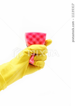 A yellow cleaning glove with a sponge against a white background A yellow cleaning glove with a sponge against a white background 11135317