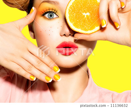 Teen girl with freckles, red hairstyle, yellow makeup and nails 11136632