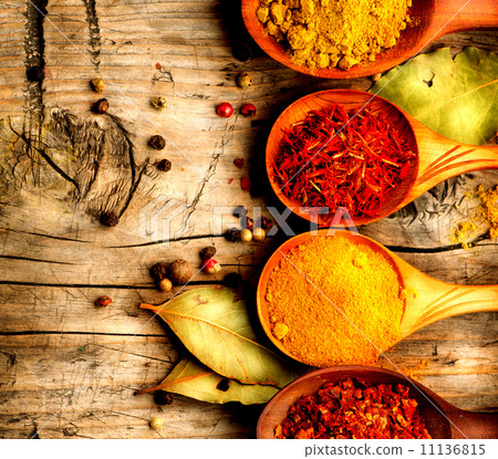 Spices and herbs. Curry, saffron, turmeric, cinnamon over wood Spices and herbs. Curry, saffron, turmeric, cinnamon over wood 11136815