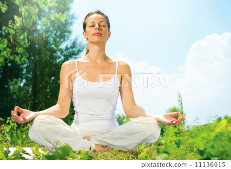 Young Woman doing Yoga Exercises Outdoor 11136915