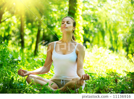 Young Woman doing Yoga Exercises Outdoor 11136916