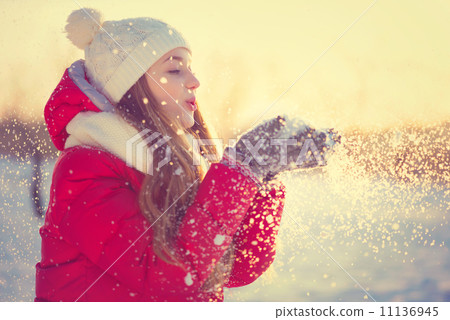 Beauty Winter Girl Blowing Snow in frosty winter Park. Outdoors 11136945