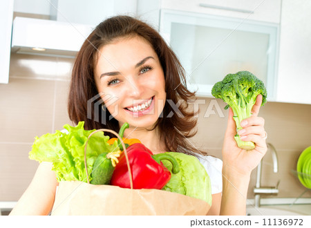 Happy Young Woman with vegetables in shopping bag. Diet Concept Happy Young Woman with vegetables in shopping bag. Diet Concept 11136972
