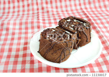 Chocolate roll cake on plate 11138017