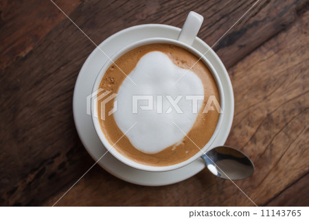 a cup of cappucino on wooden table a cup of cappucino on wooden table 11143765