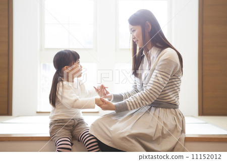 Girls holding hands with their mothers 11152012