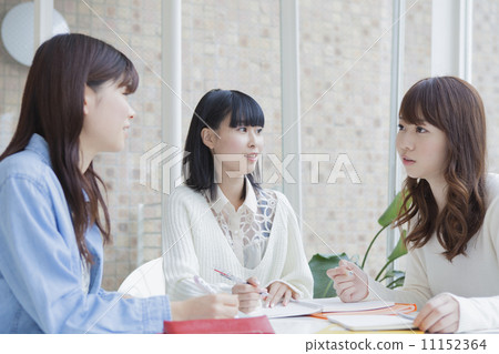Girls studying together at the table Girls studying together at the table 11152364