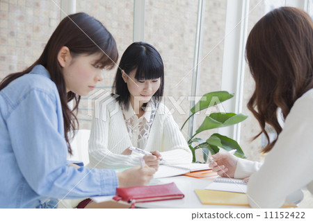 Girls studying together at the table 11152422