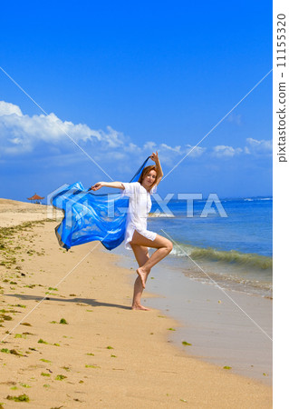 The young beautiful woman on an ocean coast. Indonesia. Bali... 11155320