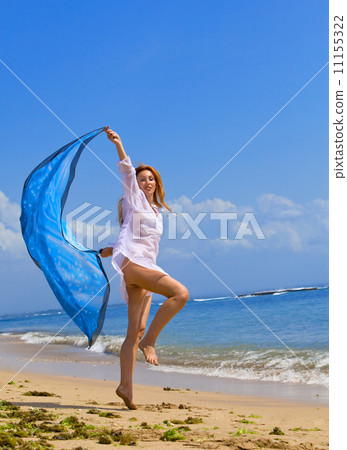 The young beautiful woman on an ocean coast. Indonesia. Bali... 11155322