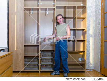 The man is engaged in repair and furniture assemblage.. 11155882