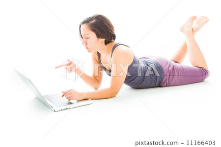 Young woman lying on floor using a laptop 11166403