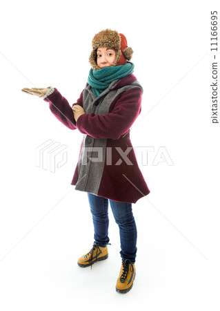 Young woman in warm clothing and showing something 11166695