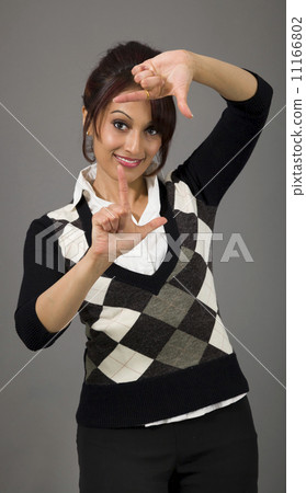 Indian businesswoman looking through finger frame 11166802