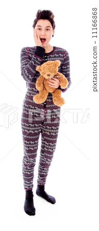 Young woman standing with her teddy bear and looking shocked 11166868