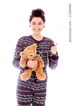 Young woman holding teddy bear and showing thumbs up sign Young woman holding teddy bear and showing thumbs up sign 11166884