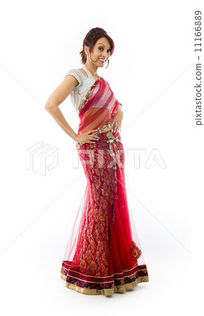 Young Indian woman standing with her arms akimbo 11166889