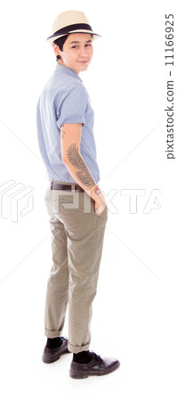 Side profile of a young woman standing with her hands in pockets 11166925