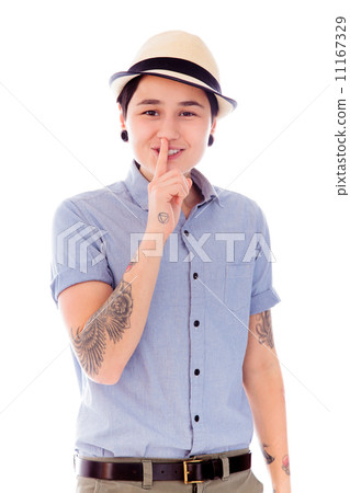 Young woman standing with finger on lips 11167329