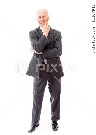 Businessman standing with hand on chin 11167912