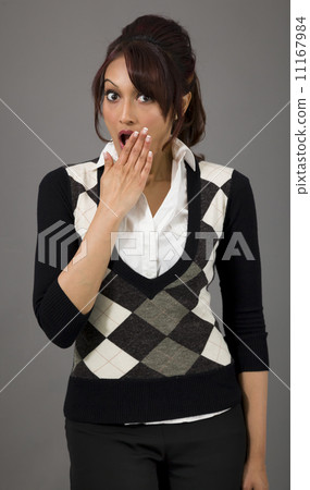 Shocked Indian young woman with hand over mouth isolated on colored background 11167984
