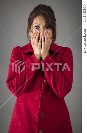 Shocked Indian woman with hand over mouth isolated on colored background Shocked Indian woman with hand over mouth isolated on colored background 11168390