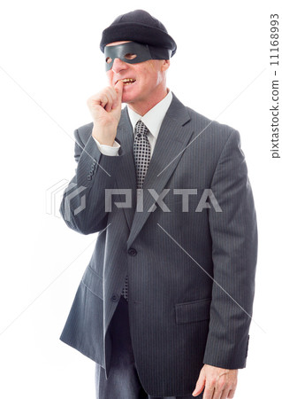Businessman wearing eye mask and standing with finger in mouth 11168993