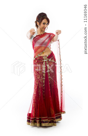 Smiling young Indian woman pointing towards camera from both hands 11169346