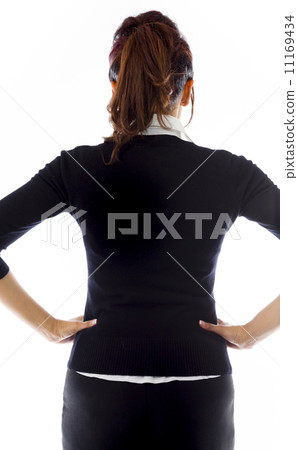Rear view of Indian businesswoman standing with her arms akimbo 11169434