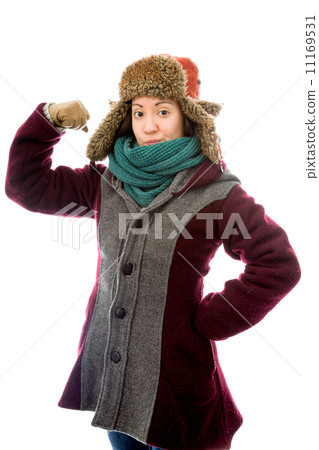 Young woman in warm clothing and flexing biceps Young woman in warm clothing and flexing biceps 11169531