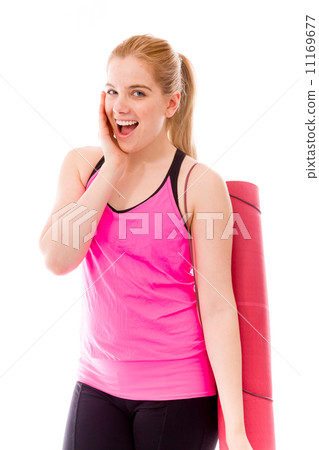 Young woman carrying exercising mat and looking excited Young woman carrying exercising mat and looking excited 11169677