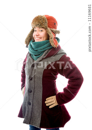 Young woman in warm clothing and standing with her arms akimbo Young woman in warm clothing and standing with her arms akimbo 11169681