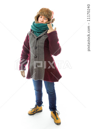 Young woman in warm clothing and staring at point of hand gun 11170240