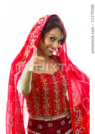 Smiling young Indian woman showing thumb up sign Smiling young Indian woman showing thumb up sign 11170506