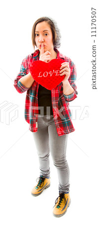 Young woman holding heart shape with a finger on lips 11170507