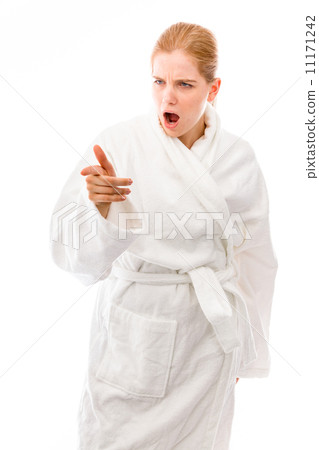 Young woman standing in bathrobe looking anger and pointing Young woman standing in bathrobe looking anger and pointing 11171242