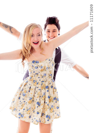 Lesbian couple standing with arm outstretched Lesbian couple standing with arm outstretched 11171609