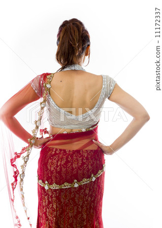 Rear view of a young Indian woman standing with her arms akimbo 11172337