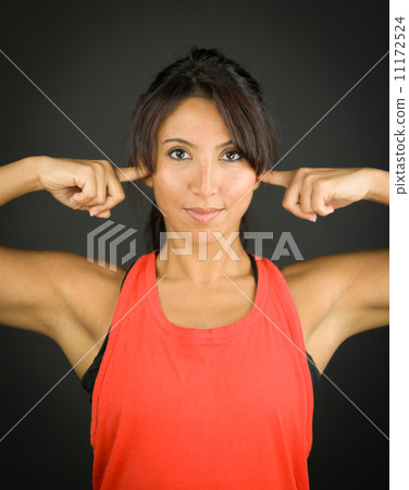 Portrait of a young woman closing her ears with her fingers 11172524